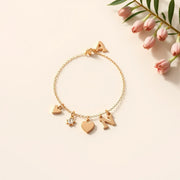 Custom charm bracelet with interchangeable heart, star, and gemstone charms on a neutral background