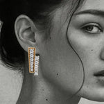 Load image into Gallery viewer, Close-up of a woman wearing diamond earrings From Silvilus with a blurred background