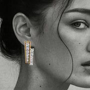 Close-up of a woman wearing diamond earrings From Silvilus with a blurred background