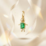 Load image into Gallery viewer, Gold pendant with a green gemstone on a beige background
