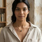 Load image into Gallery viewer, Woman wearing a necklace with a visible pendant in an indoor setting