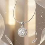 Load image into Gallery viewer, Silver necklace with a round, diamond-studded pendant against a soft, blurred background.