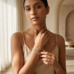 Load image into Gallery viewer, Woman wearing a colorful bracelet in a softly lit room