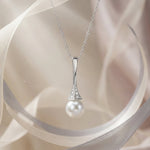 Load image into Gallery viewer, Pearl necklace with silver chain on a soft fabric background